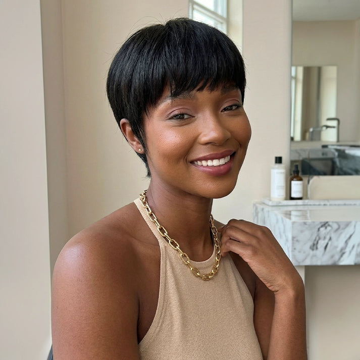 Vintage Chic Pixie Cut with Natural Hair Full Bangs Drawn Sideburns
